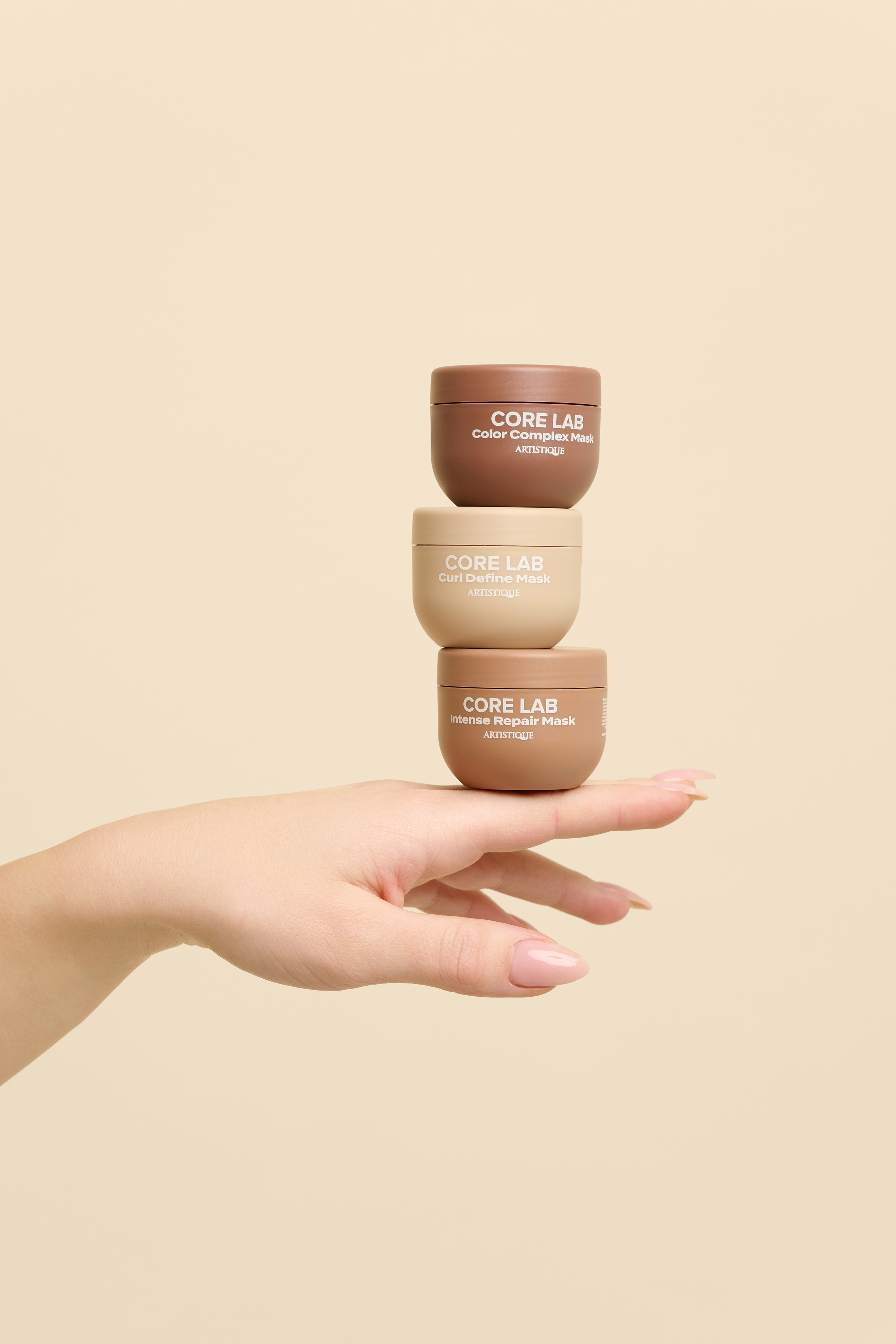 Product photography for Artistique - hand model showcasing haircare product, Studio Taupe